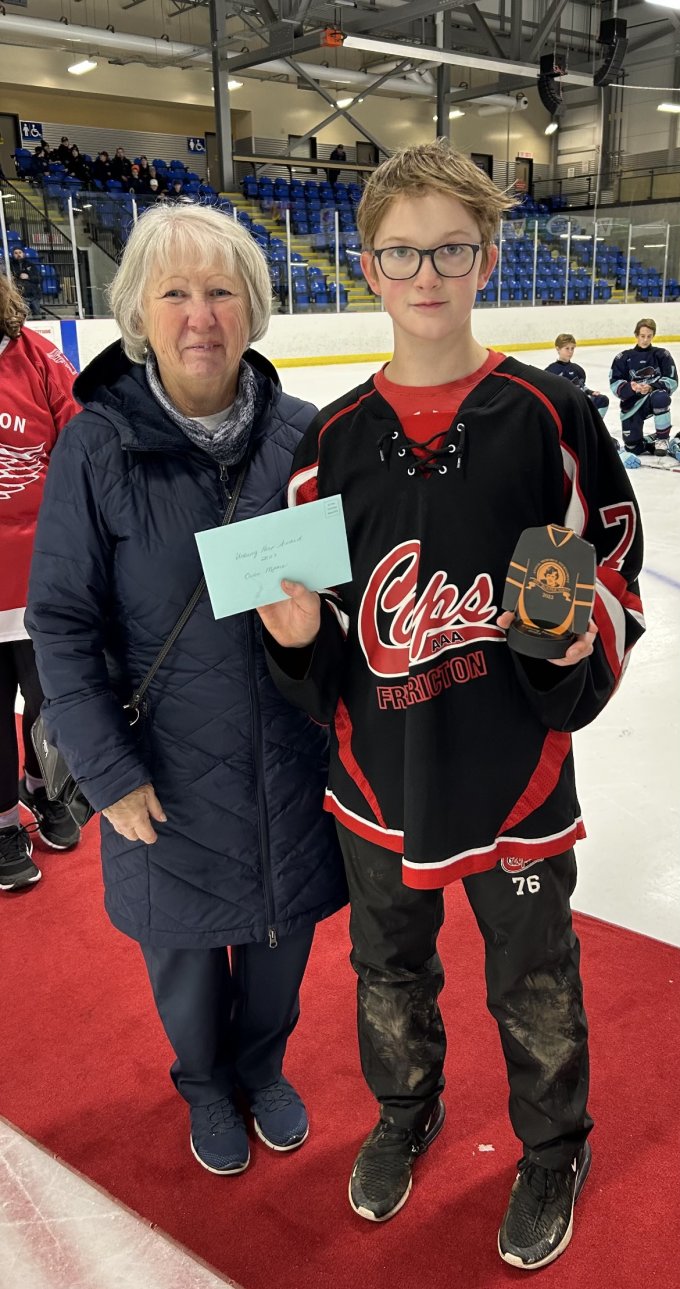 Kris Harvey Presenting Unsung Hero Award to Owen Moore from the Fredericton Caps